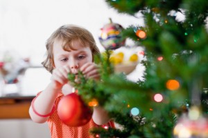Girl Hanging Ornament on Tree